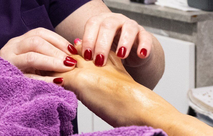 Reflexology pressure-point treatment on a client’s feet